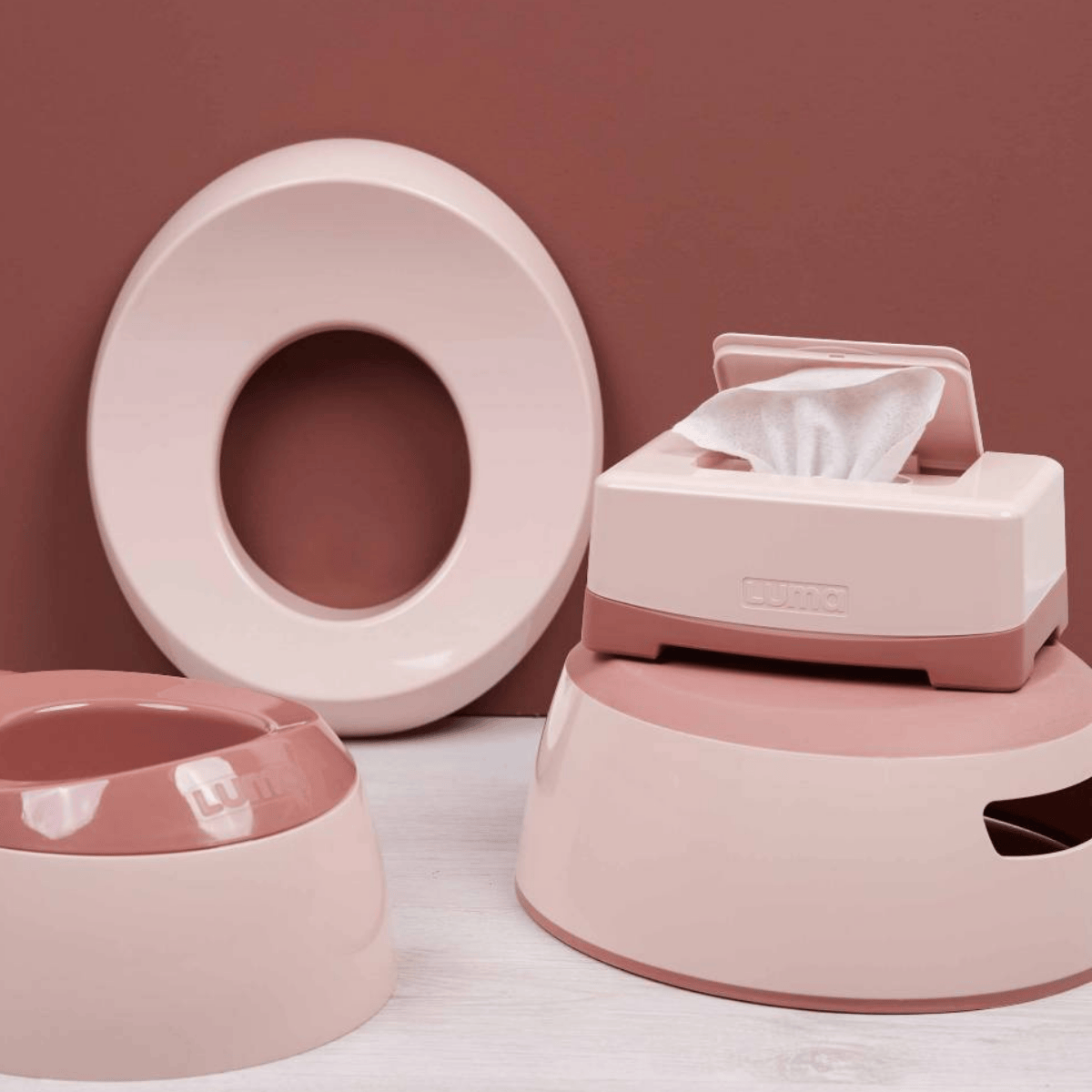 Pink wet wipes on a white surface with a pink background