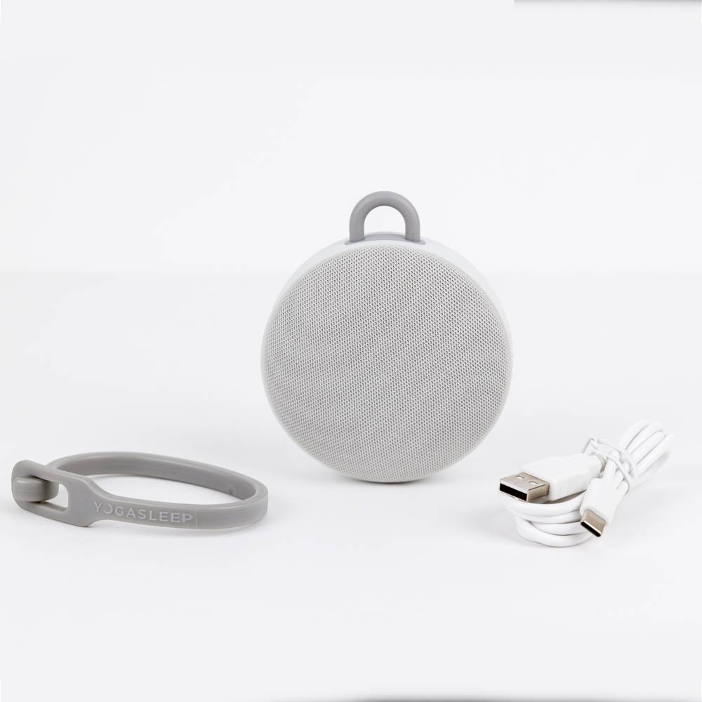 Gray portable speaker with band and cable on a white background