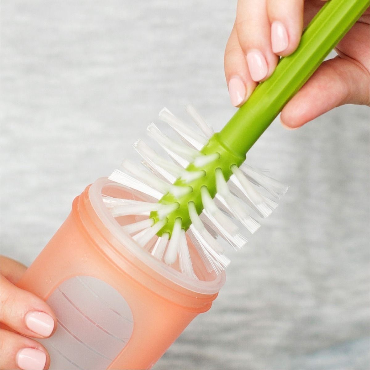 Mum cleaning her bottle with one of the brushes.