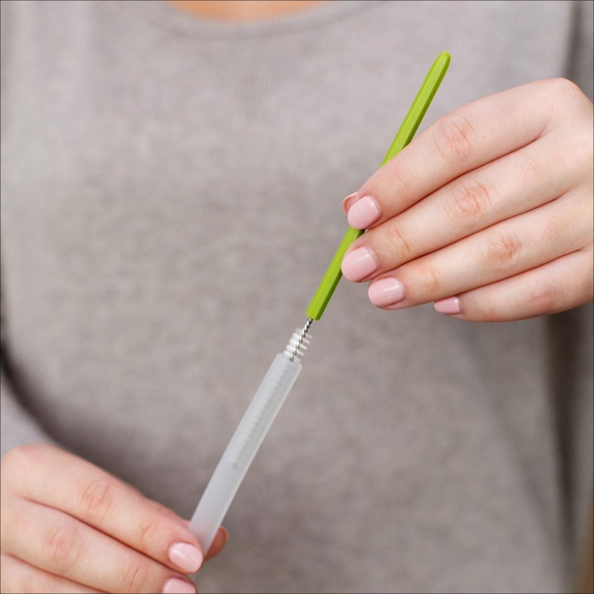 A straw brush cleaning the inside of a straw.