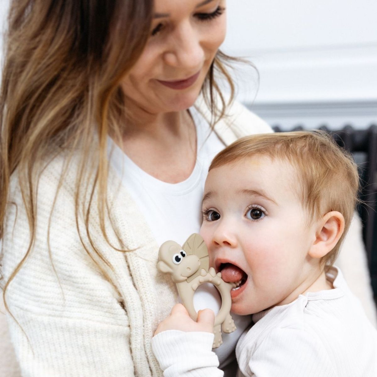Mum holding teething baby.