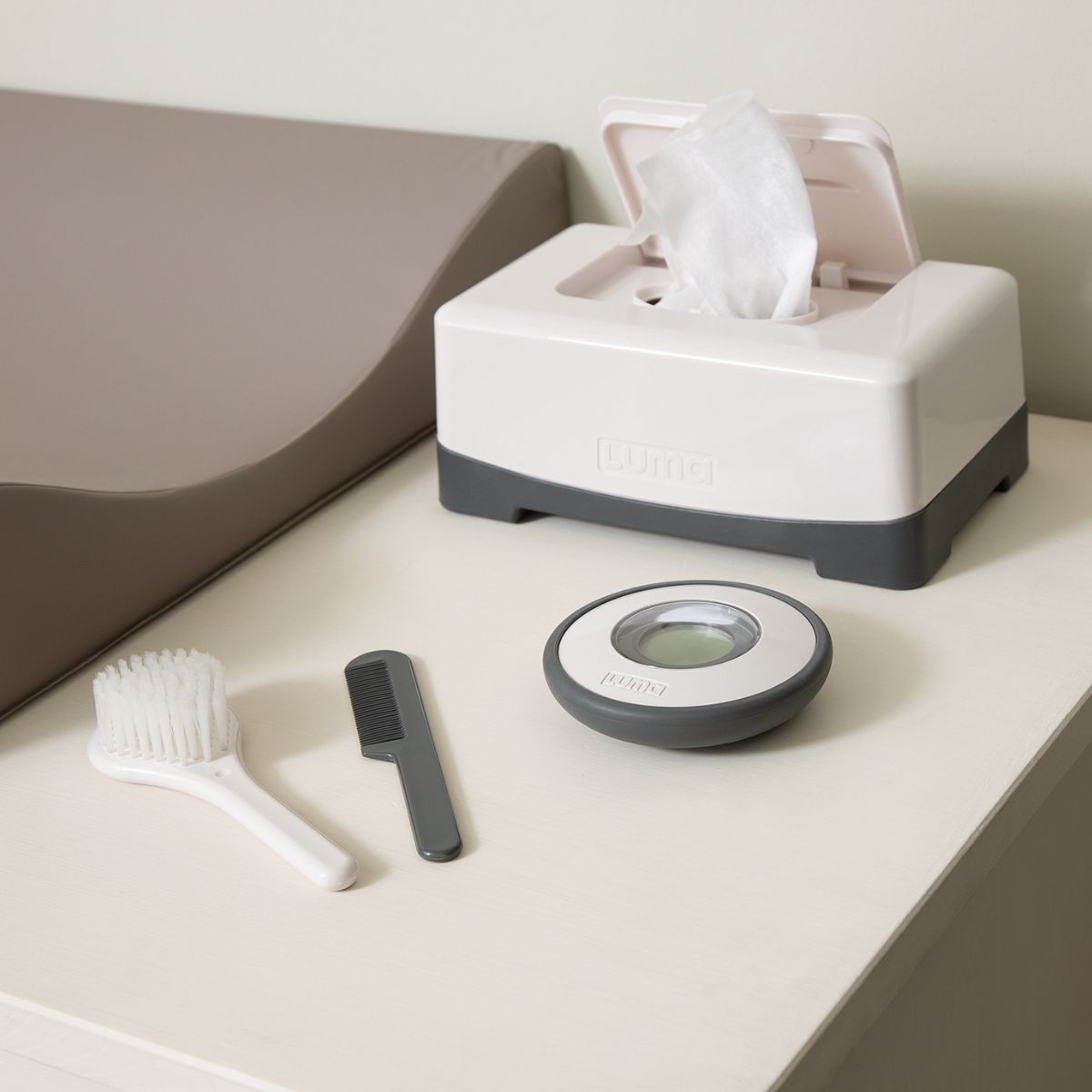 The LUMA brush and comb set on the babies change table.