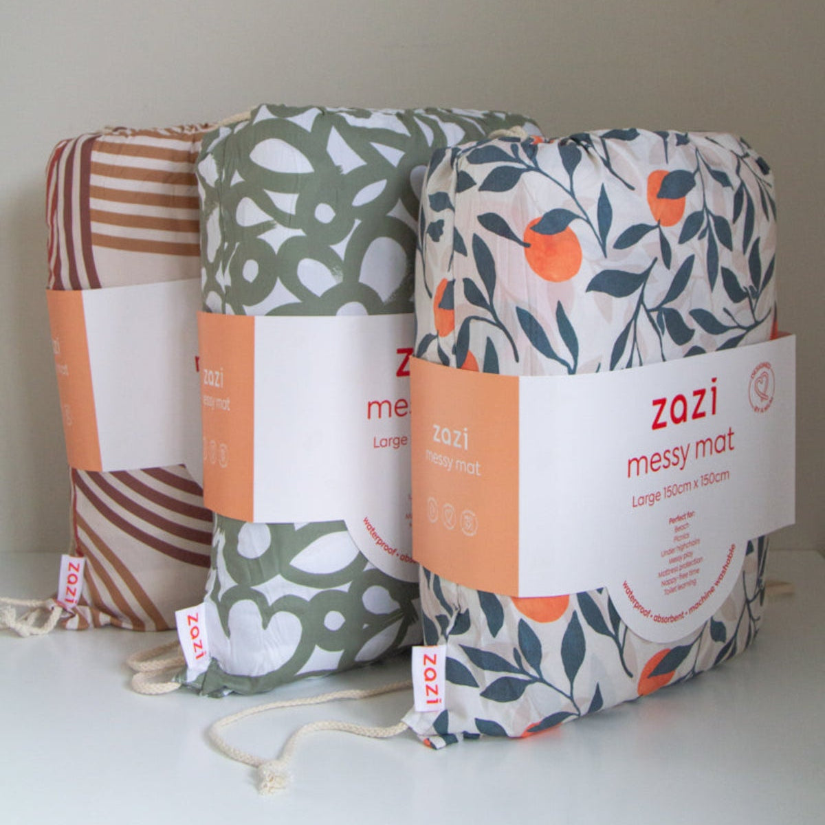Three Zazi messy mats with different patterns on a white background