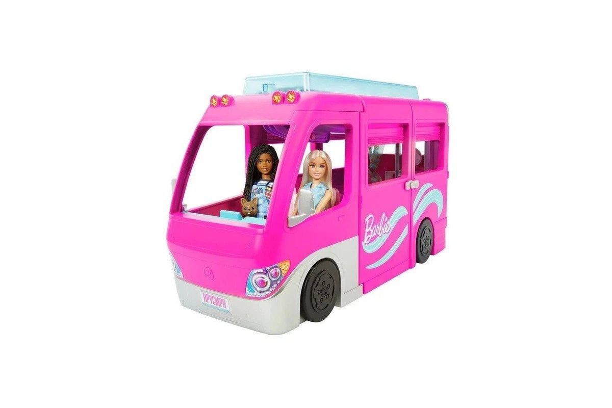 Pink toy bus with dolls inside on a white background
