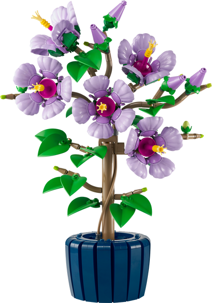 Toy tree with purple flowers and green leaves in a blue pot on a white background
