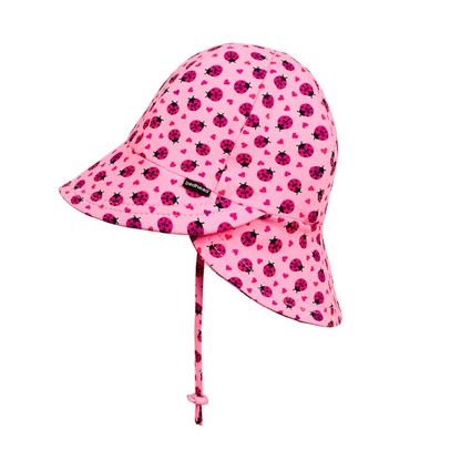 Pink children's sun hat with ladybug pattern on a white background