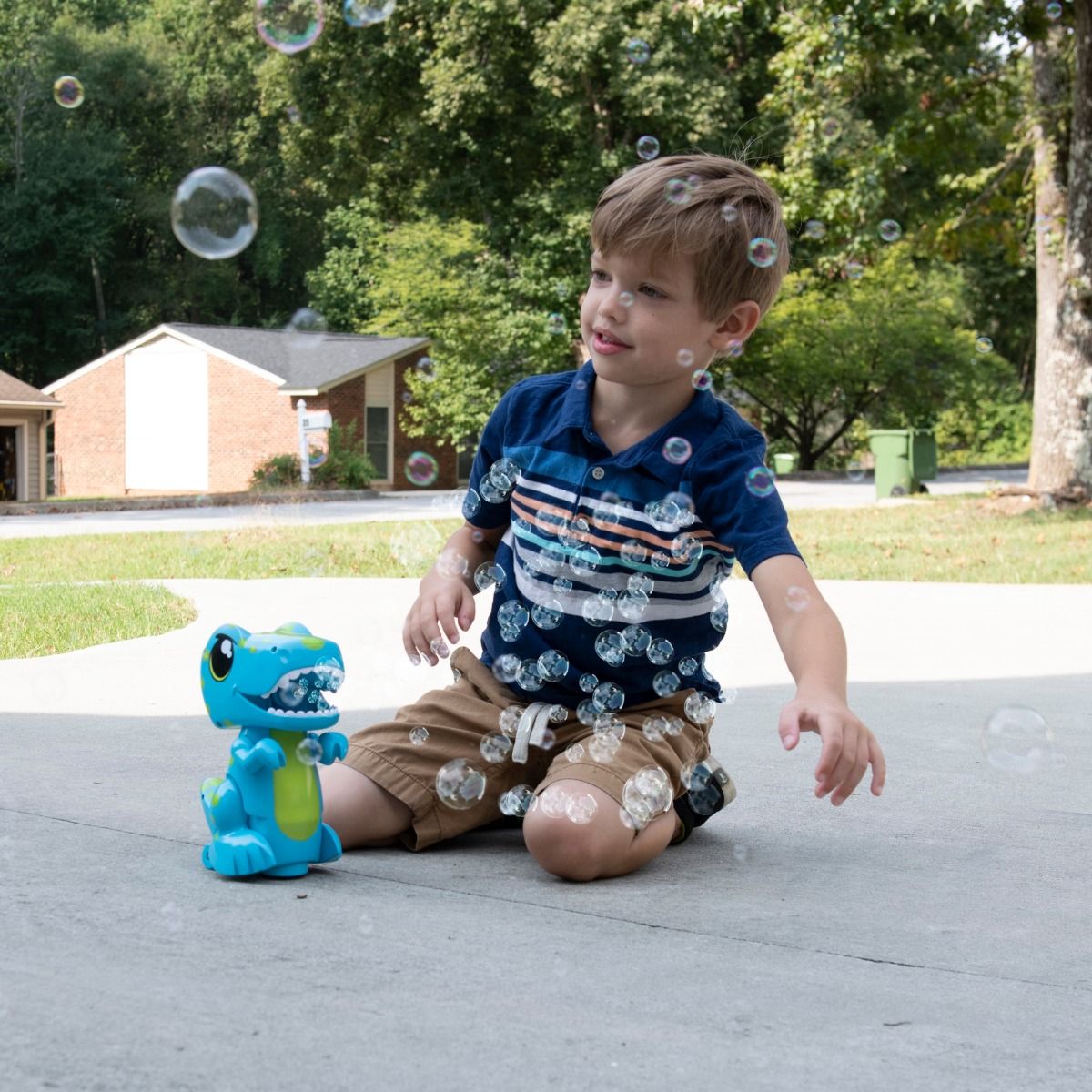 Child playing with Bump N Go Dinosaur Bubble Maker outdoors on a sunny day