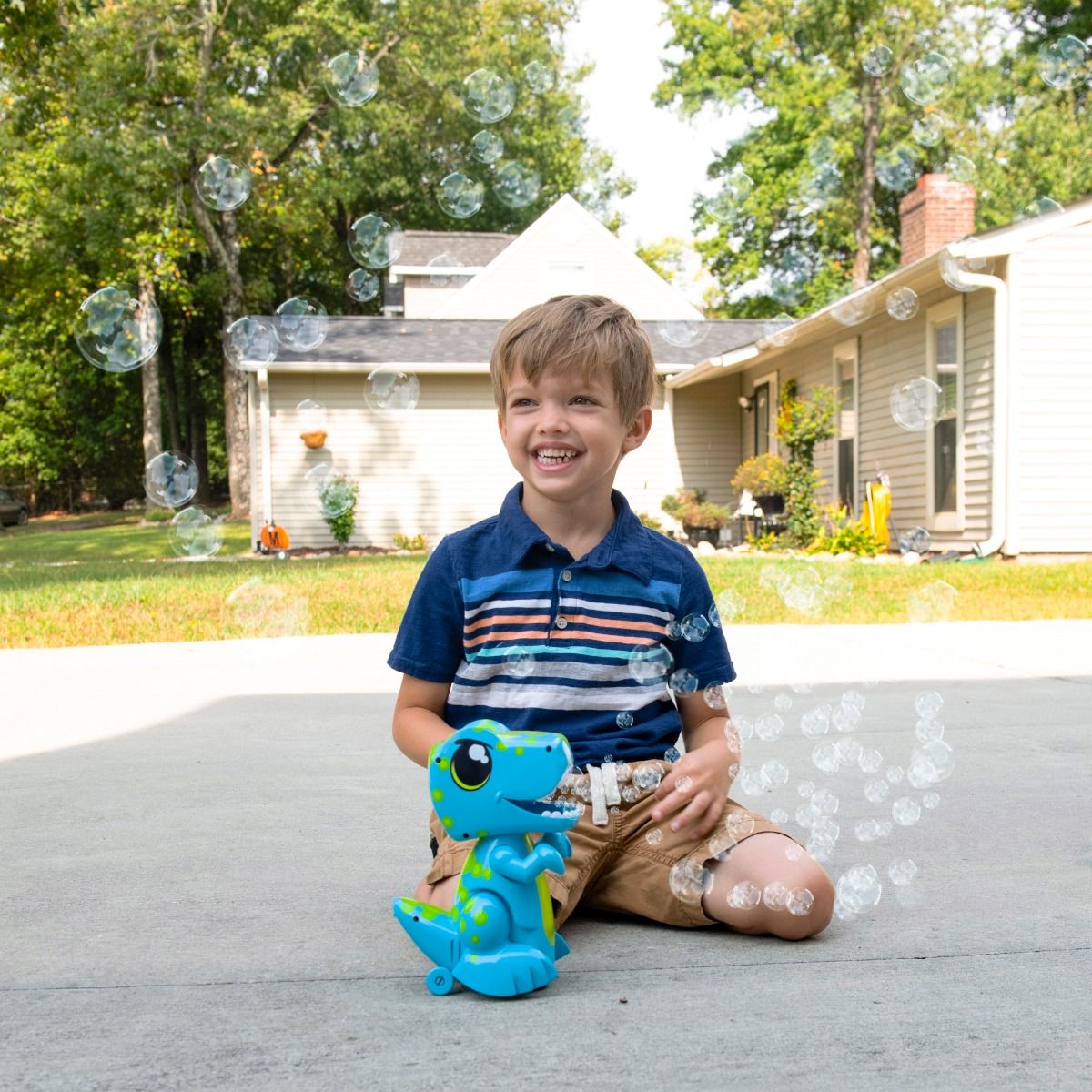 Child playing with Bump N Go Dinosaur Bubble Maker toy outdoors on a sunny  day