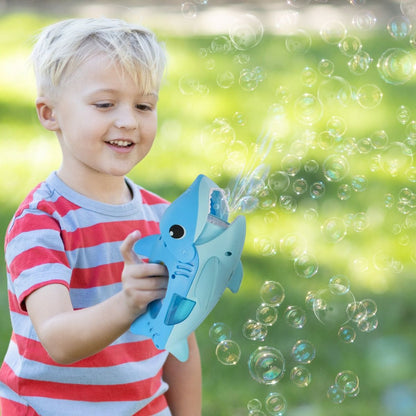 Child playing with a bubble gun in a park