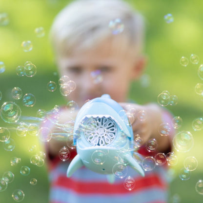 Blue shark-shaped bubble gun and child