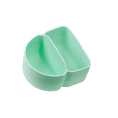 Mint green silicone cupcake liner on a white background