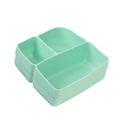 Stack of three green divided plates on a white background