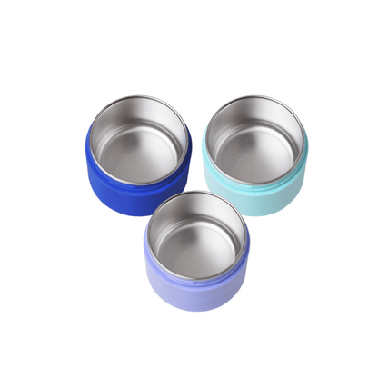 Three small round stainless steel bowls with different colored outer rims, shown on a plain white background.