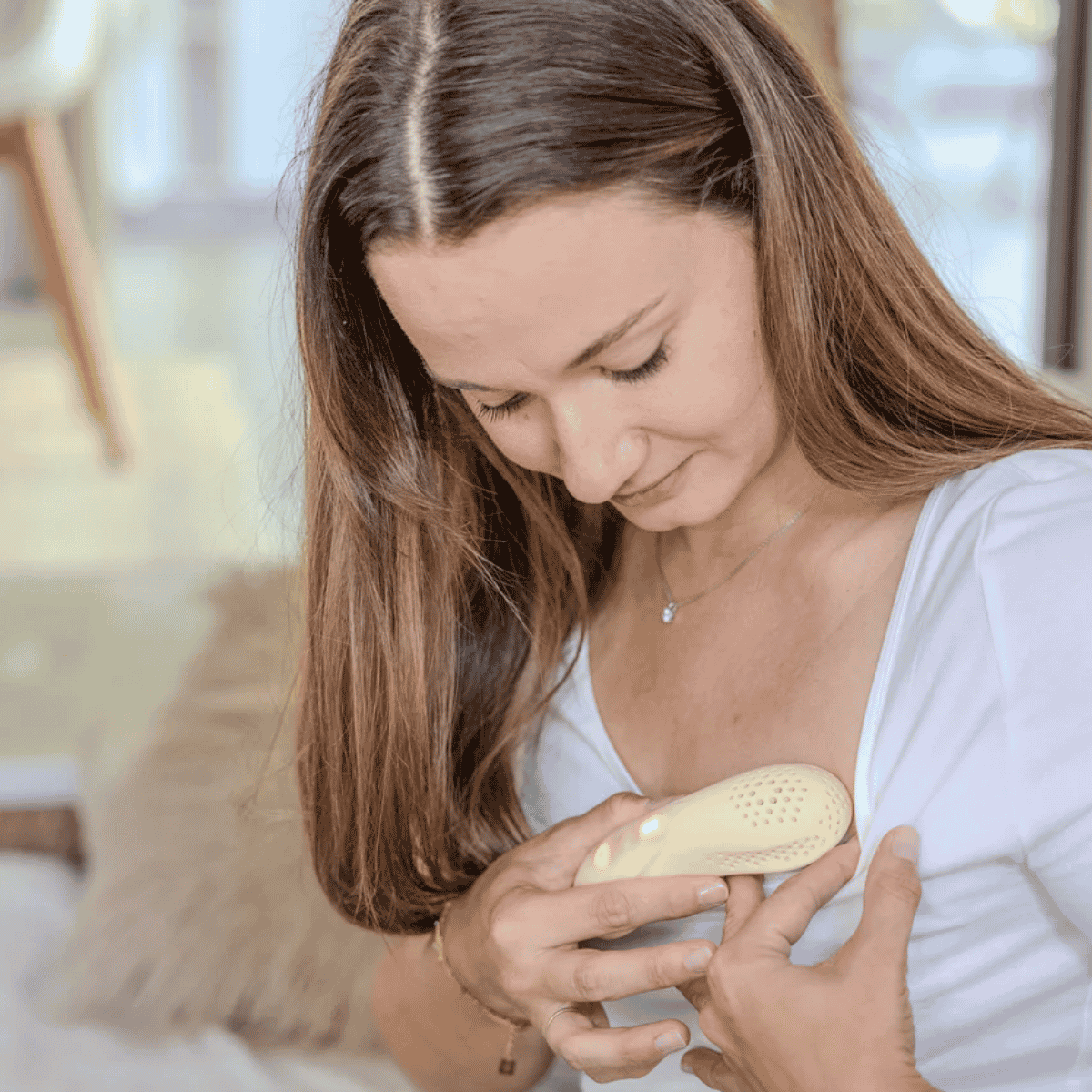 Beige electronic device suitable for breast massage to assist with breastfeeding with perforated design  