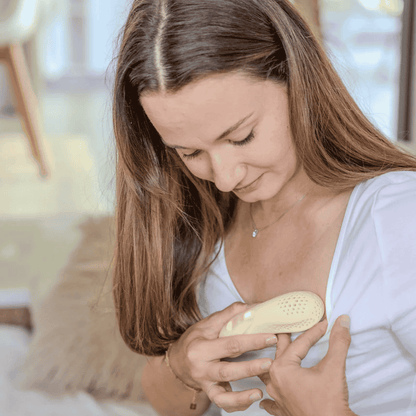 Beige electronic device suitable for breast massage to assist with breastfeeding with perforated design  