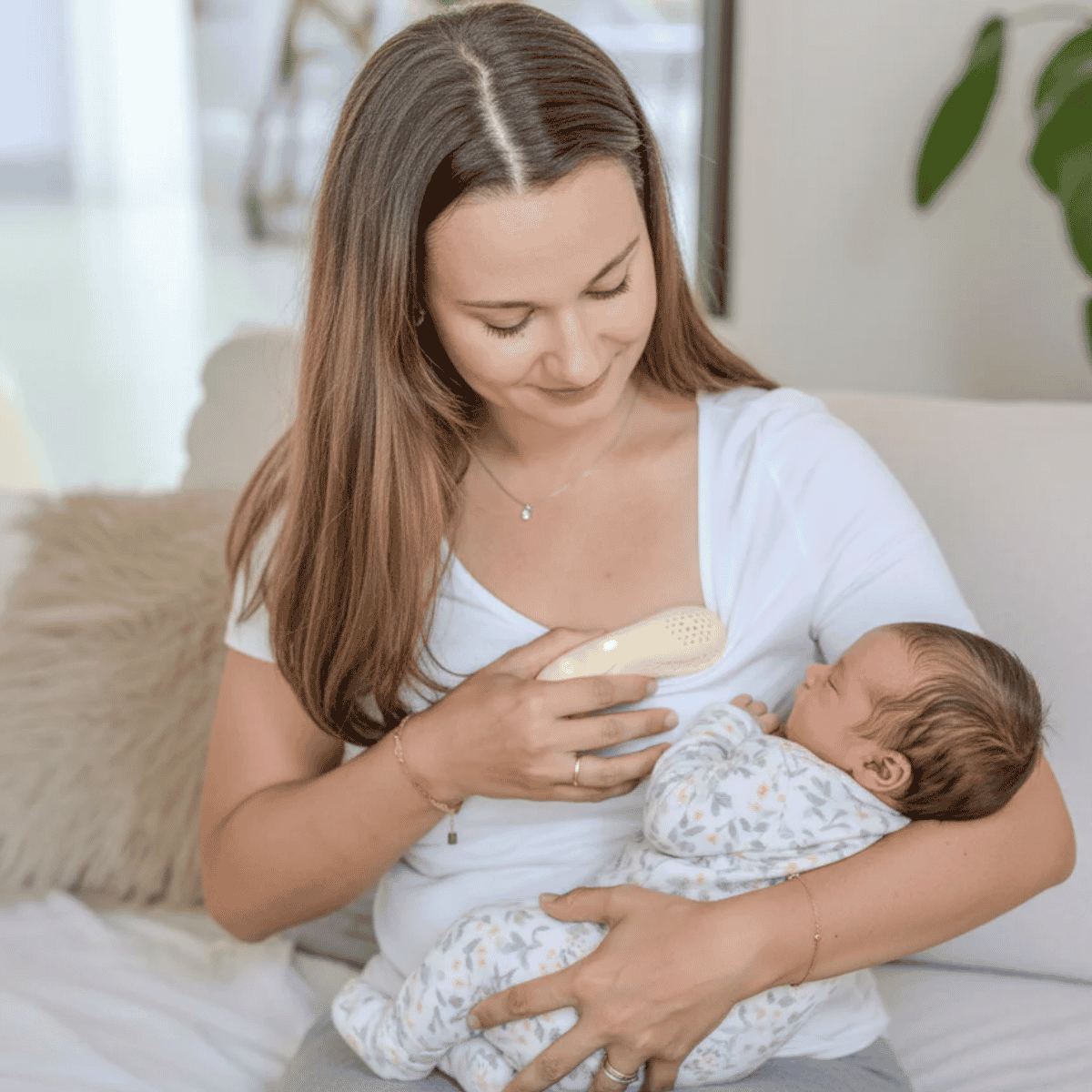 Beige electronic device suitable for breast massage to assist with breastfeeding with perforated design on a white background