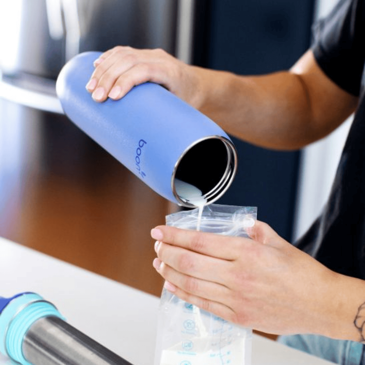 Boon - FROSH™ Stainless Steel Portable Milk Chiller  being put into a storage bag 
