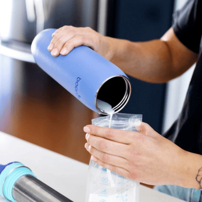 Boon - FROSH™ Stainless Steel Portable Milk Chiller  being put into a storage bag 