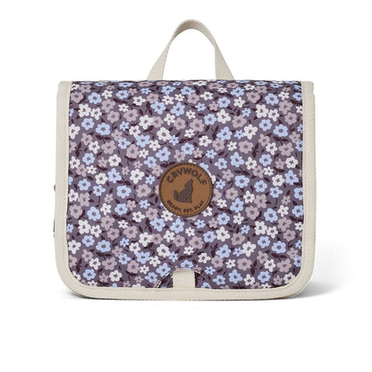 A hanging toiletry bag with a purple flower design for kids to take away on holiday or to keep their bathroom organised.
