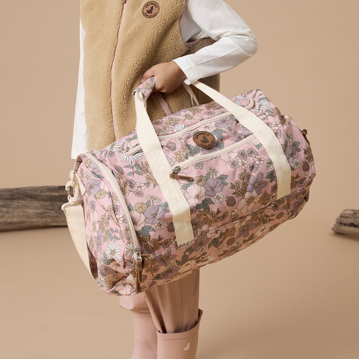 Side view of the floral pink duffel bag.