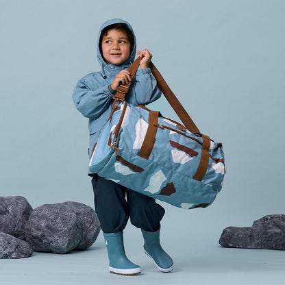 A boy wearing his Crywolf Packable Duffle Bag.