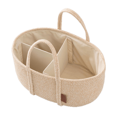 Beige woven baby crib with divided sections on a white background