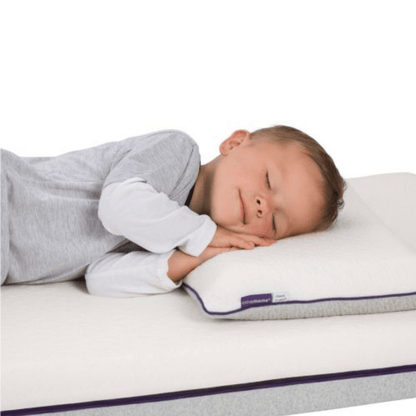 Child sleeping on a pillow with a visible brand logo on a white background