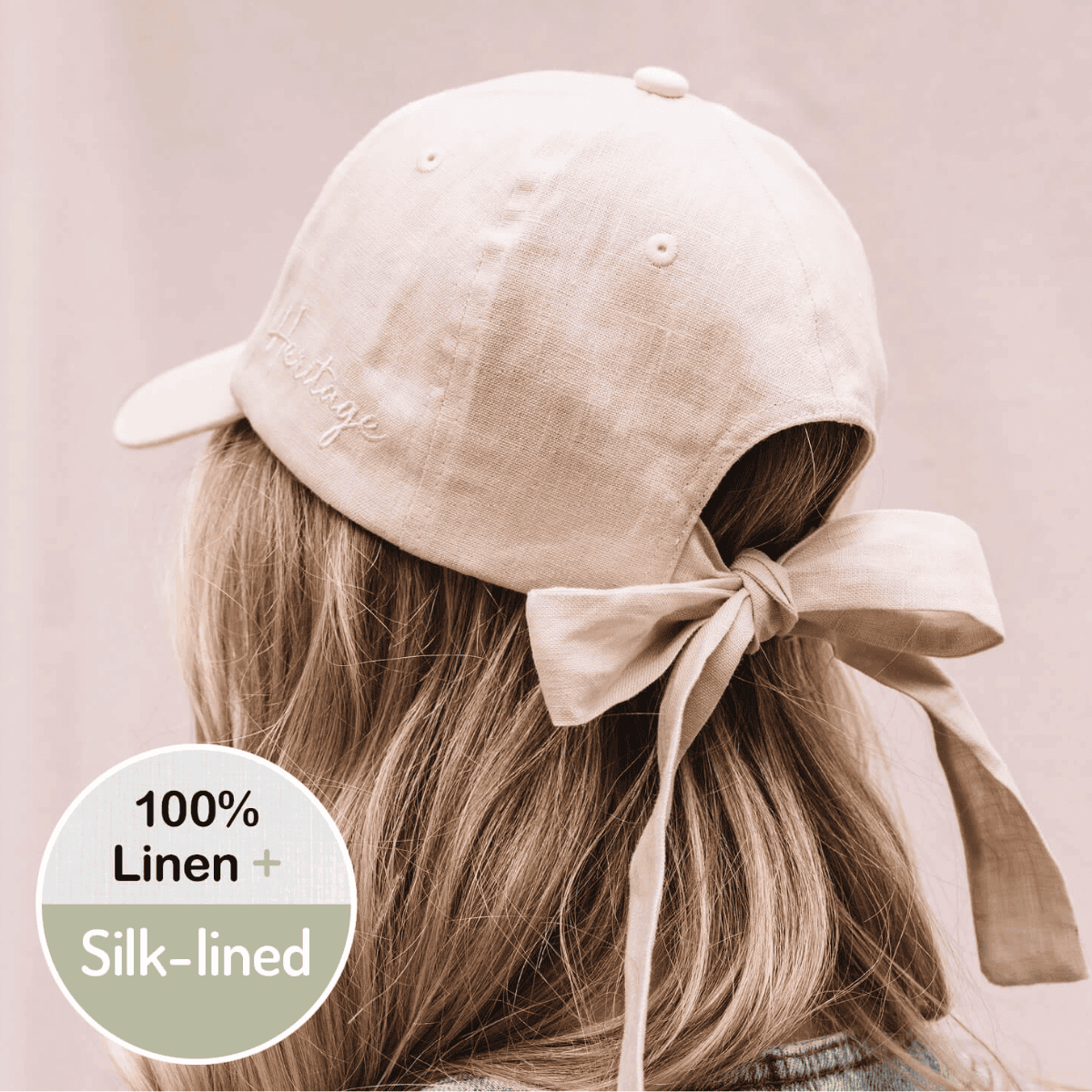 Beige linen cap with silk lining worn by a person, on a light pink background.