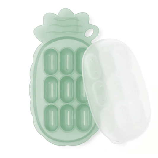 Mint green pineapple-shaped food cube tray with a clear lid on a white background