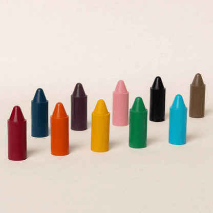 Row of colorful crayons on a beige background