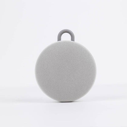 Gray portable speaker on a white background