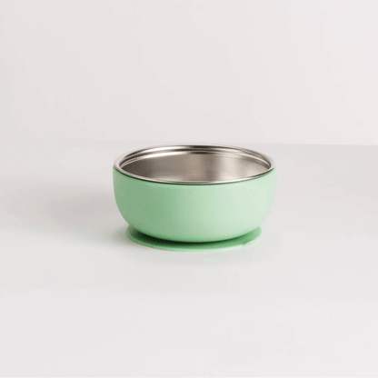 Green  bowl with silver stainless steel interior on a white background