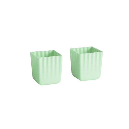 Two small mint green square containers with vertical fluted sides, shown on a plain white background.