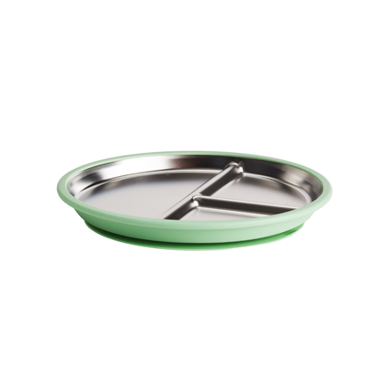 A round divided baby plate with a stainless steel interior and a light green silicone outer rim and suction base, shown on a plain white background.