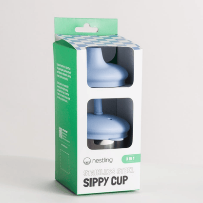Blue sippy cup in a green and white packaging box on a light gray background