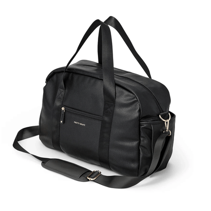 Black duffel bag with shoulder straps on a white background