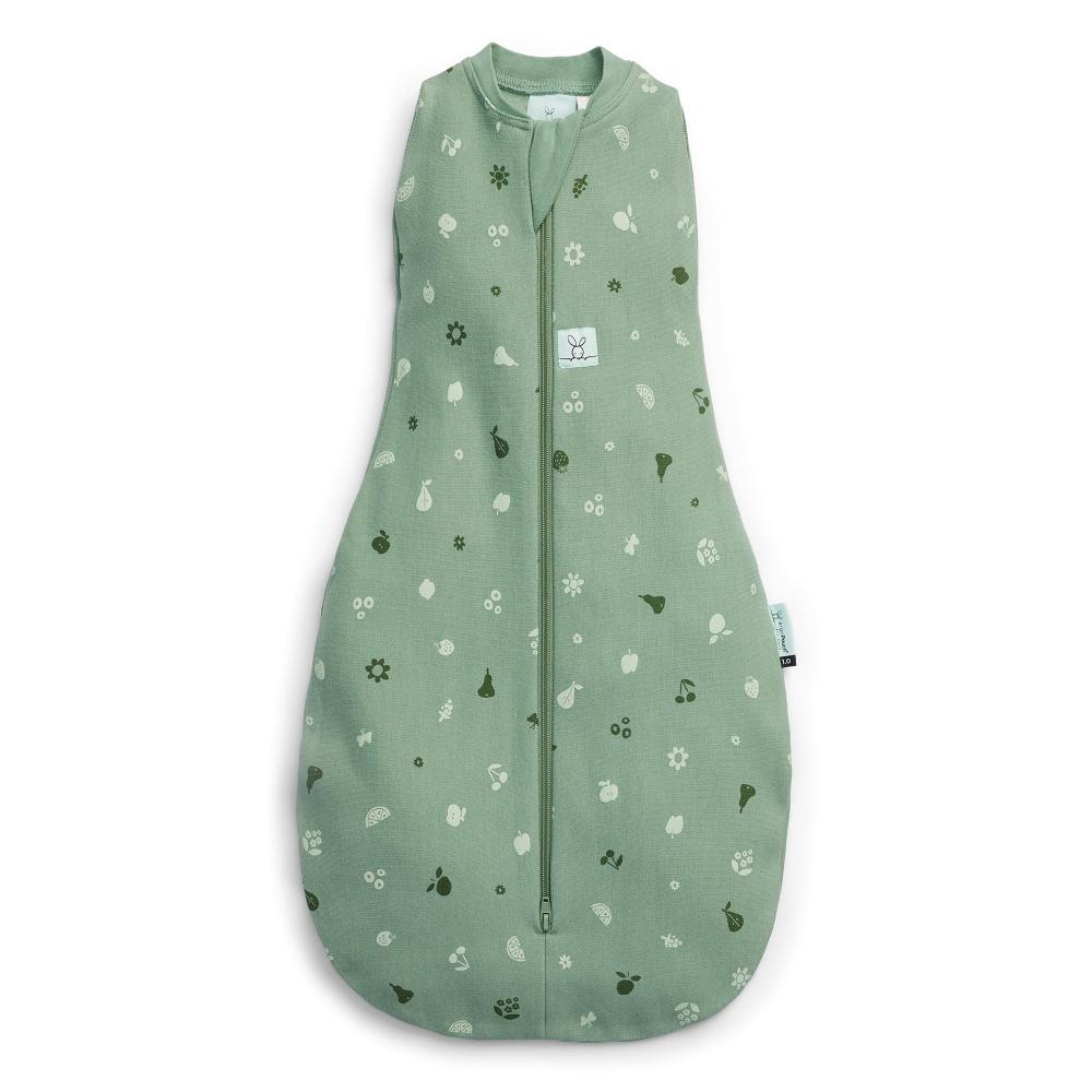 A green ergoPouch Cocoon Swaddle Bag with a zip-up enclosure and small animal and nature print, designed for newborns and babies.