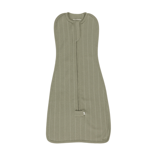Green baby sleeping bag swaddle with a visible brand label on a white background