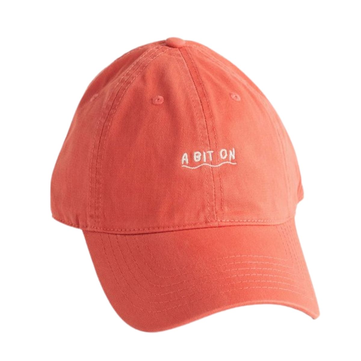 A bright coral hat with the words 'a bit on'