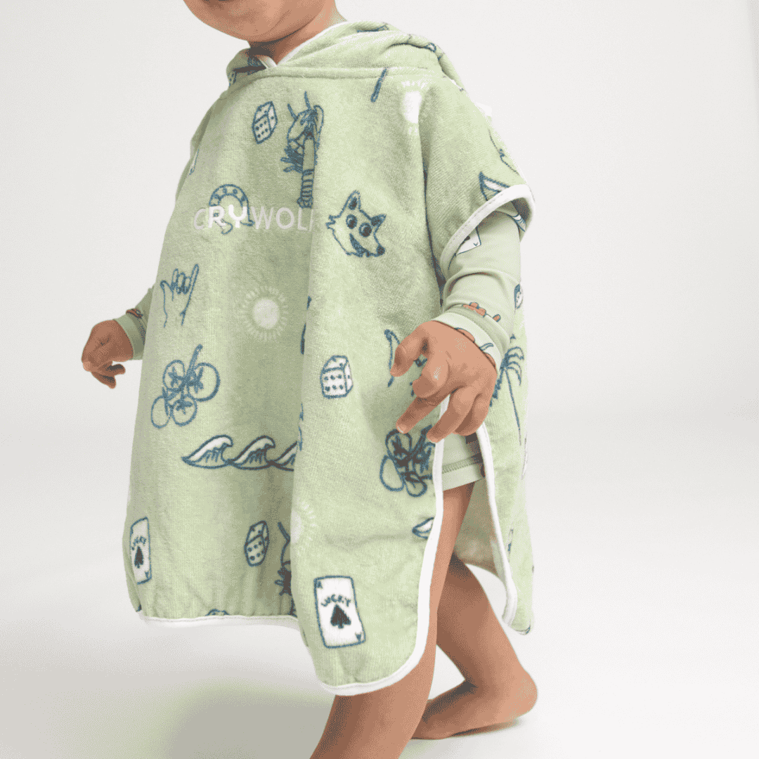 A boy wearing the green characters hooded towel.