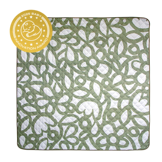 Green and white patterned baby blanket with an award badge on a white background