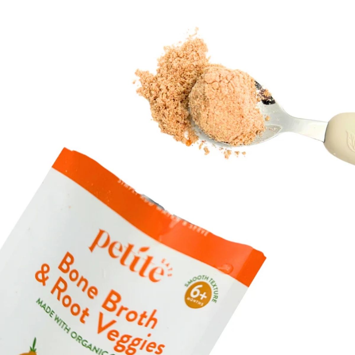 The powdered puree on a baby spoon, coming out of the packet.