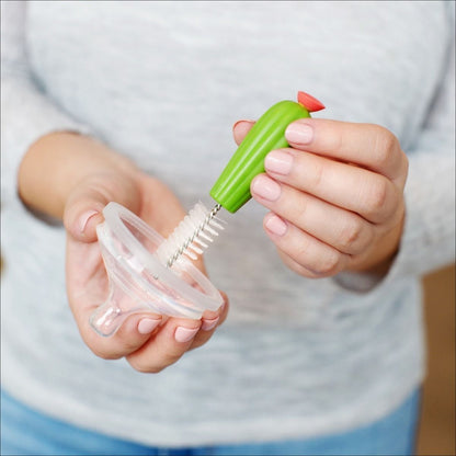 The little brush cleaning a sippy cup lid.