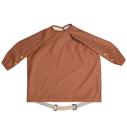 Rust coloured long sleeve bib with rainbows on a white background.