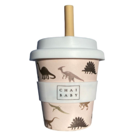 A pink bamboo children's cup with a silicone lid and a red straw, decorated with dinosaur patterns and the brand name 'Chai Baby' displayed on the front.