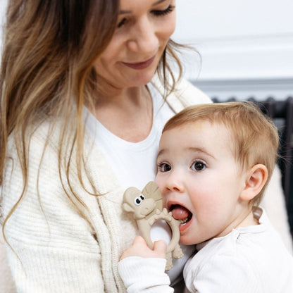 Mum holding teething baby.