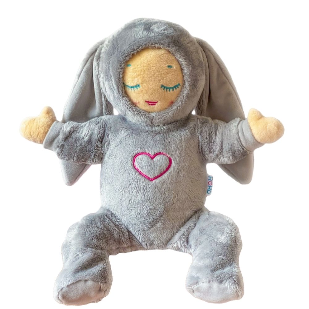 A plush Lulla doll wearing a gray two-piece outfit with a heart symbol on the bodysuit and a hood with ears, resembling a bunny.