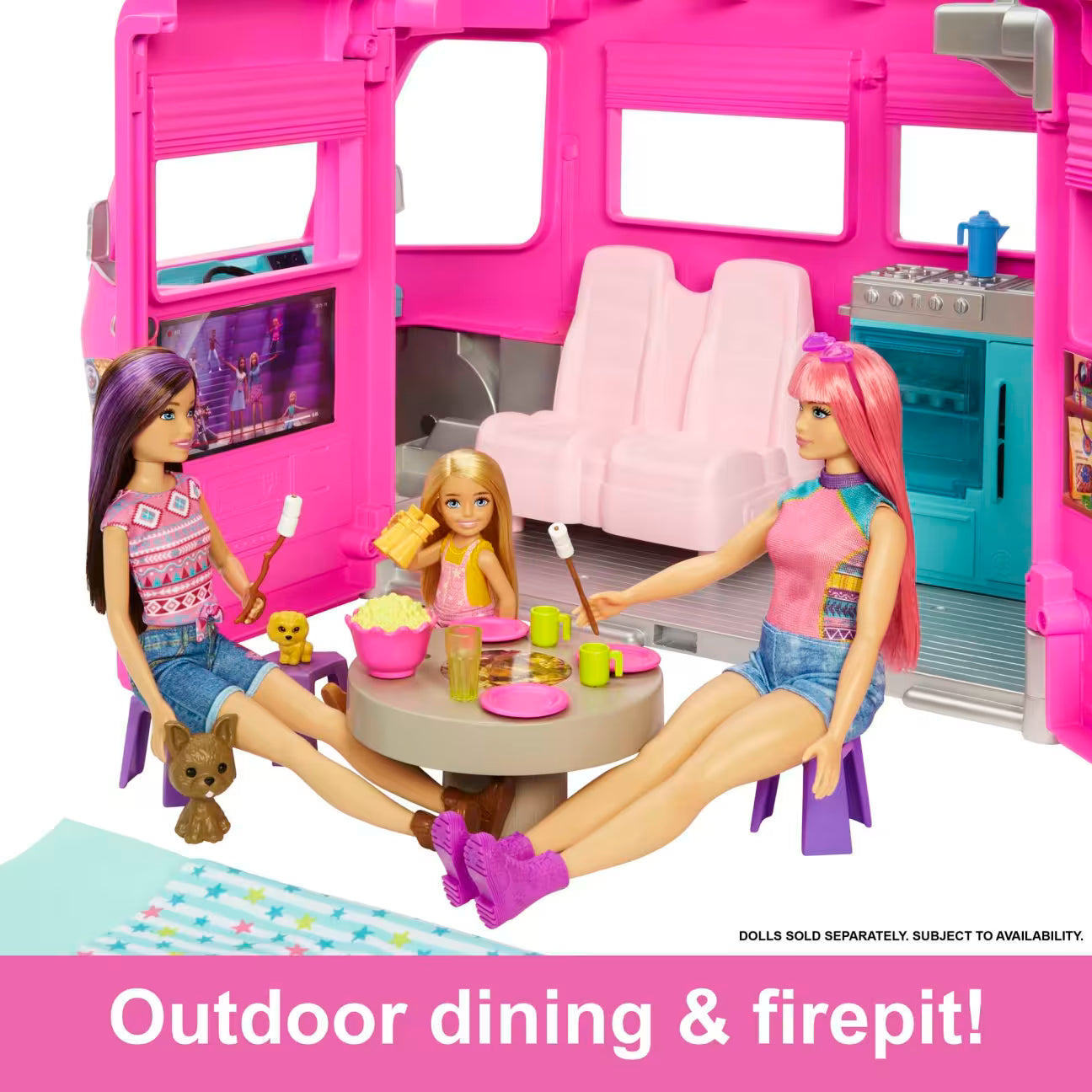 Pink toy bus with dolls around a table, featuring outdoor dining and firepit elements.