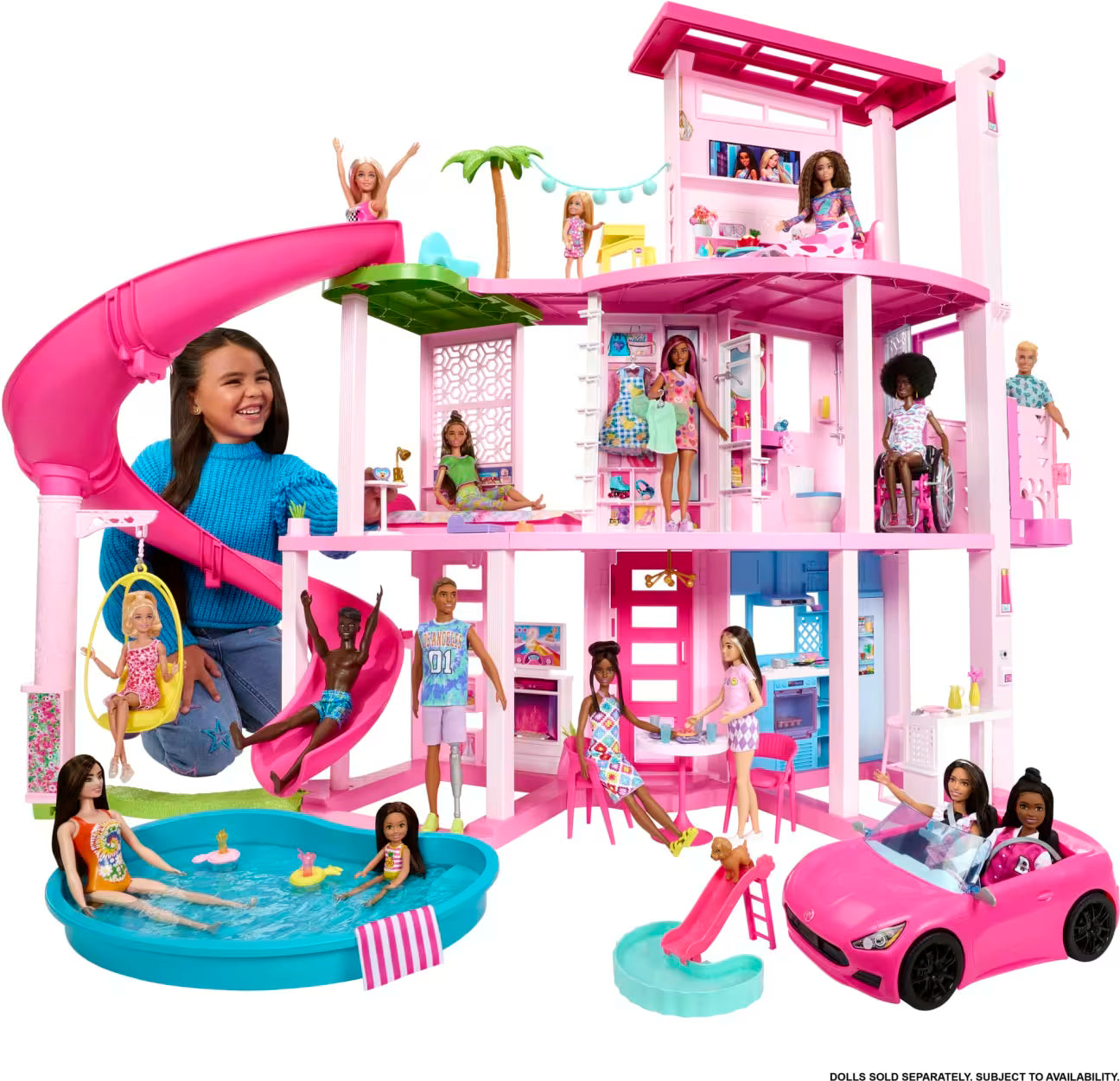 Barbie Dreamhouse with multiple dolls around it on a white background