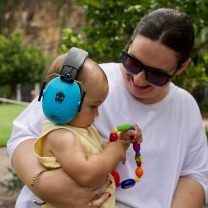 Mum with her baby who is wearing the blue earmuffs.